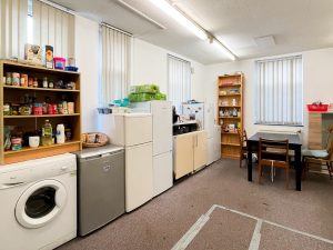 kitchen with carpeted floor and open storage