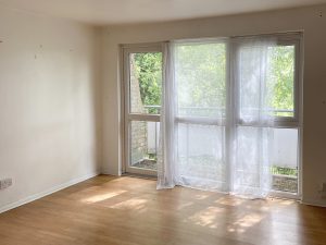 room with wooden floor and french doors