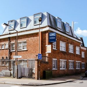 red brick building on the corner of a road