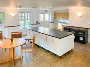 white kitchen cabinet on wooden floor