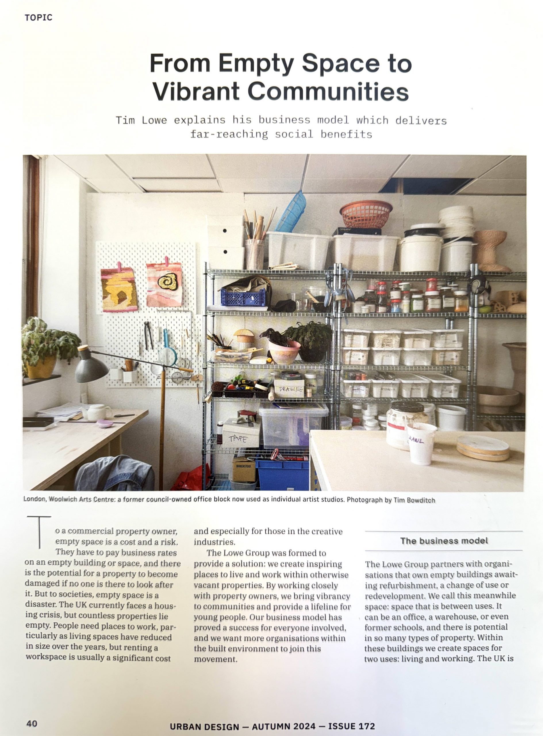 magazine article with writing and. aphpoto of an artists studios space with a map and prints on walls