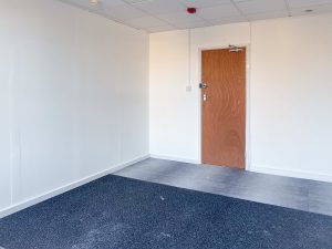 white walled room with white walls and blue carpet