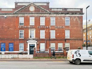 a red brick building with a sign reading 'archbishop tenison's school'