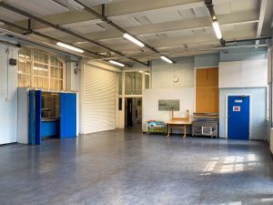 school hall with white walls and blue doors