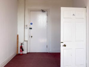 red carpeted room with white doors