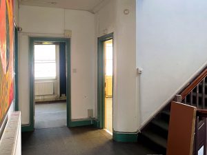 a carpeted landing with two doors