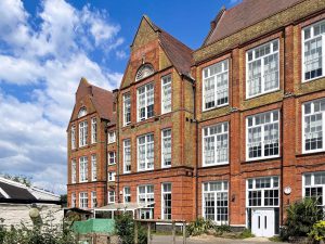 red and brown brick dour-story building with white window frames