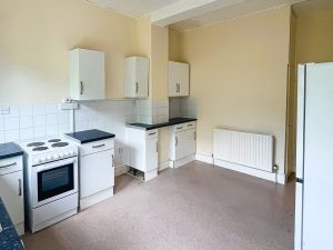 a kitchen with cabinets and oven