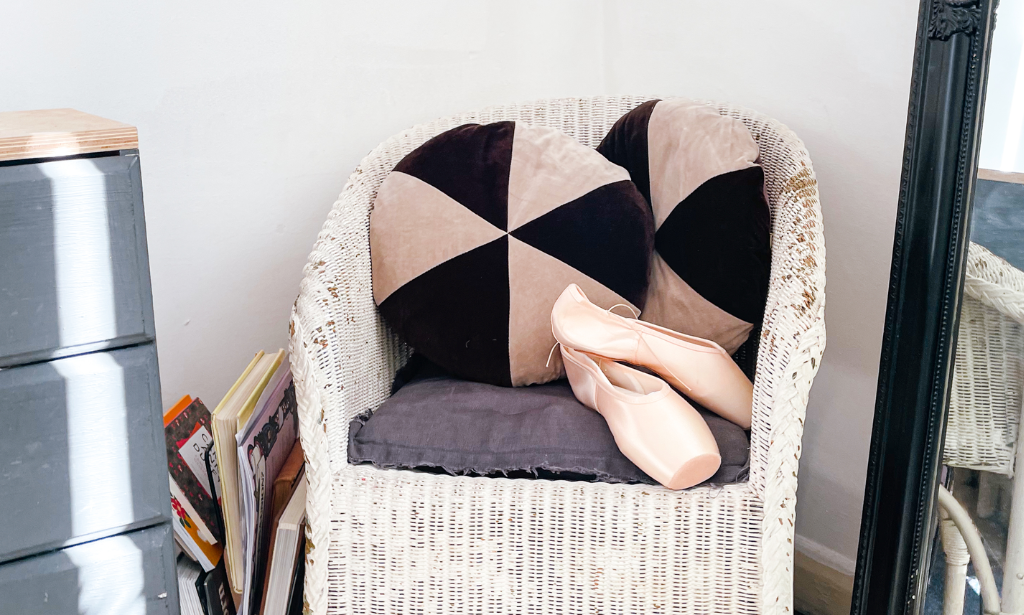 ballet shoes rest on a chair
