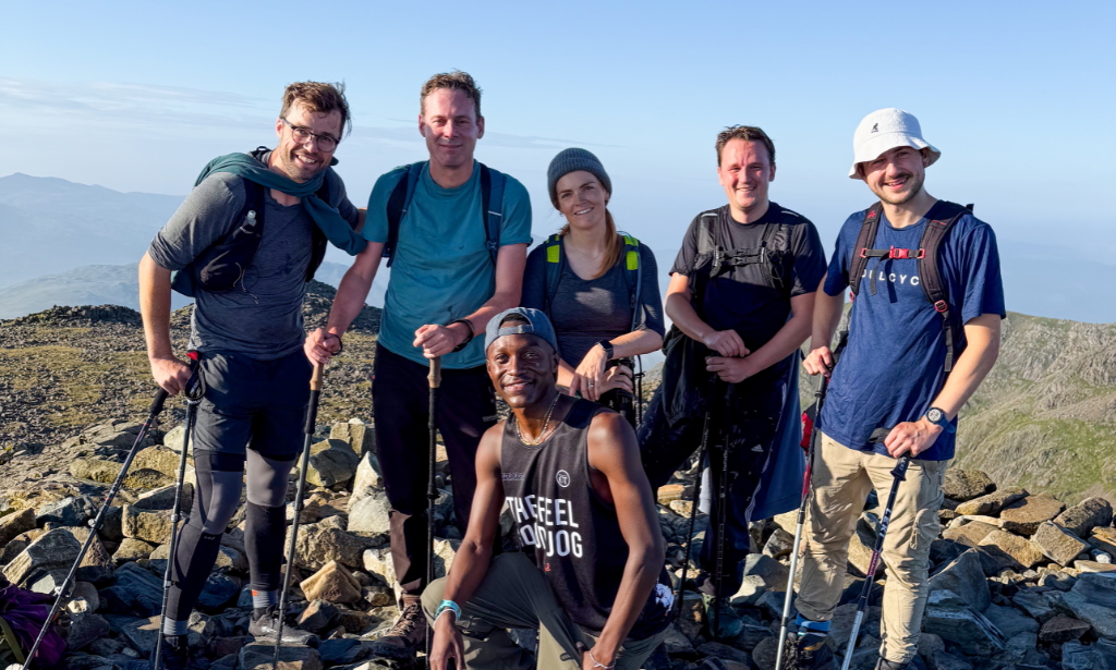a group of hikers smile at the camera