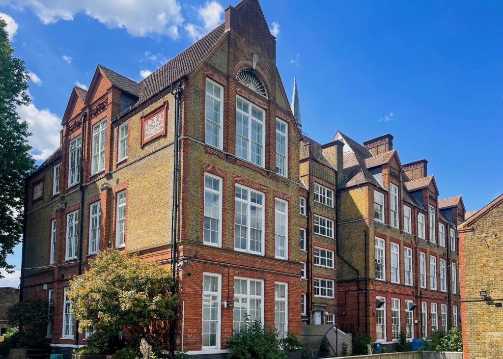 brown and red brick four-story buidling