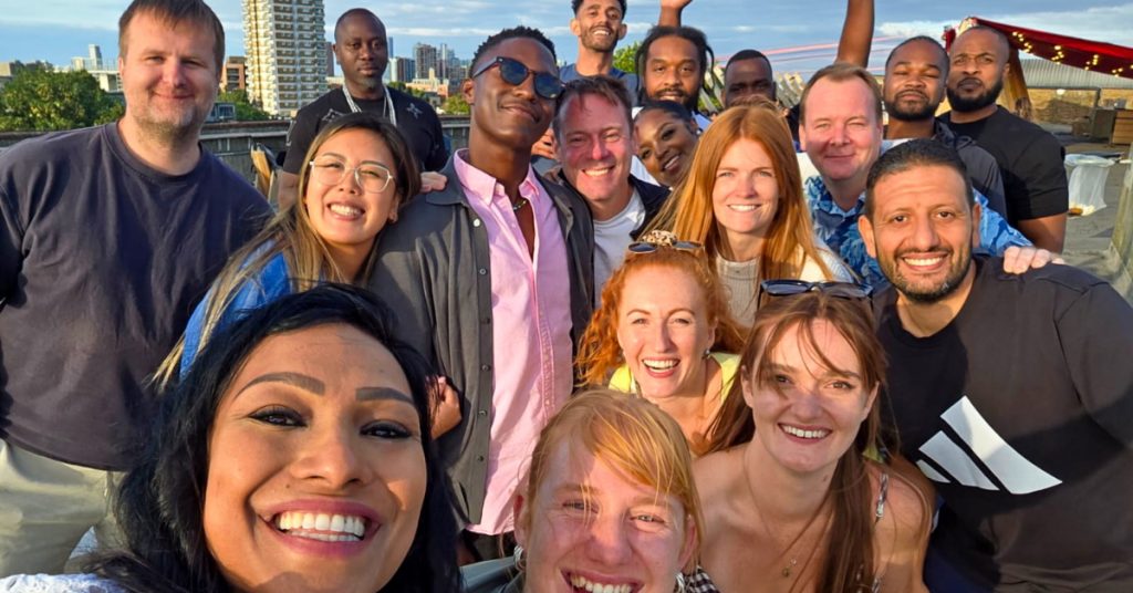 A group of people smile at camera