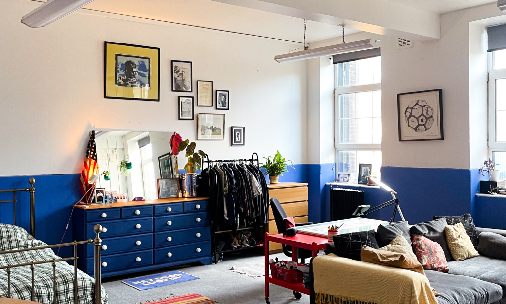 blue and white walled room containing a blue set of drawers and a couch